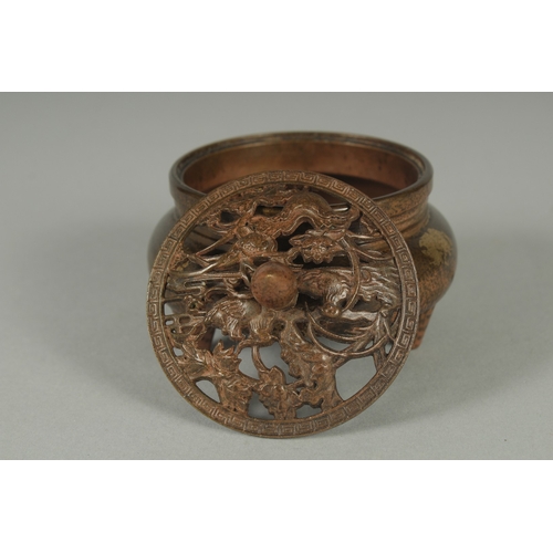 58 - A CHINESE BRONZE GOLD SPLASH CENSER AND OPENWORK COVER, on tripod legs with character mark to base, ... 