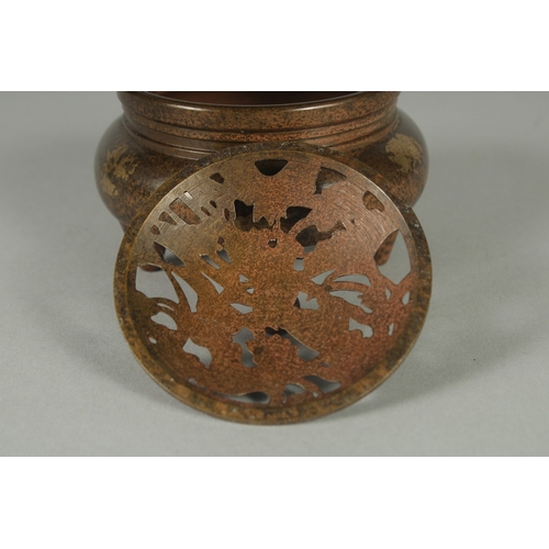 58 - A CHINESE BRONZE GOLD SPLASH CENSER AND OPENWORK COVER, on tripod legs with character mark to base, ... 