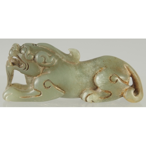 581 - A CARVED JADE LION DOG, 7.5cm long.