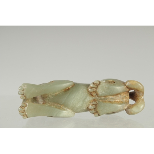 581 - A CARVED JADE LION DOG, 7.5cm long.