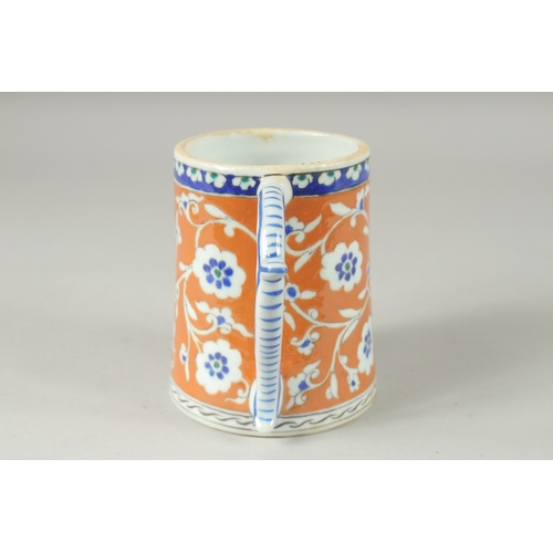 590 - AN OTTOMAN TURKISH POTTERY TANKARD, 15cm high.