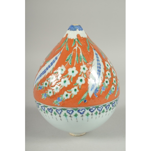 597 - AN OTTOMAN TURKISH KUTAHYA GLAZED POTTERY HANGING ORNAMENT, 20cm high.