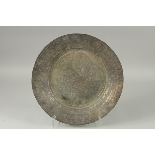 600 - A MIDDLE EASTERN ENGRAVED TINNED COPPER DISH, 43cm diameter.