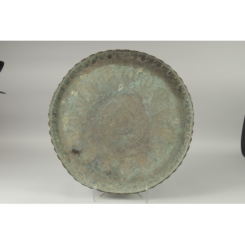 603 - A LARGE MIDDLE EASTERN ENGRAVED METAL TRAY, 61cm diameter.