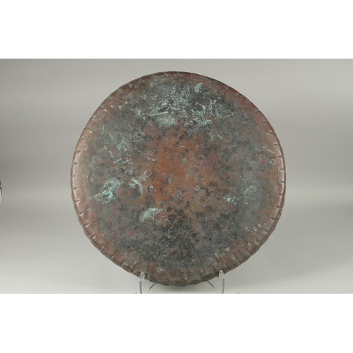 603 - A LARGE MIDDLE EASTERN ENGRAVED METAL TRAY, 61cm diameter.