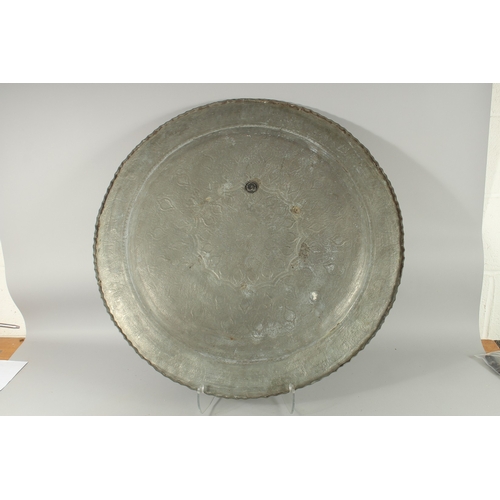 605 - A VERY LARGE ISLAMIC ENGRAVED TINNED COPPER TRAY, 78cm diameter.