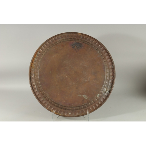 607 - AN ISLAMIC ENGRAVED TINNED COPPER DISH, with bands of calligraphy, 56cm diameter.