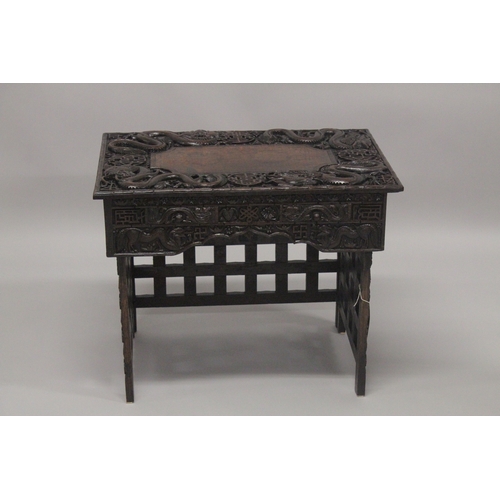 609 - AN EARLY 20TH CENTURY CHINESE HARDWOOD FOLDING DESK / TABLE, with two small drawers and folding leg ... 