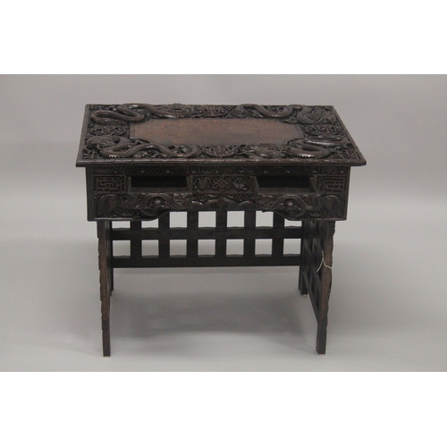 609 - AN EARLY 20TH CENTURY CHINESE HARDWOOD FOLDING DESK / TABLE, with two small drawers and folding leg ... 