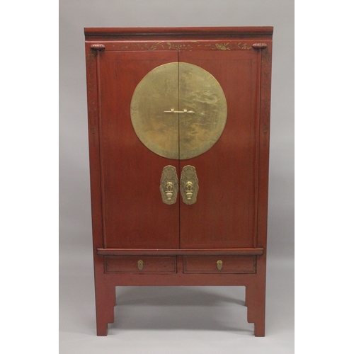 613 - A LATE 19TH - EARLY 20TH CENTURY CHINESE RED LACQUER MARRIAGE CABINET, with a pair of brass mounted ... 