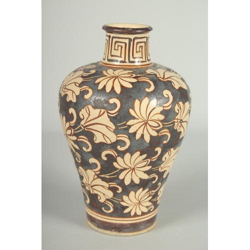 63 - A CHINESE JIZHOU KILN POTTERY VASE, with lilipad and flower head decoration, 19cm high.