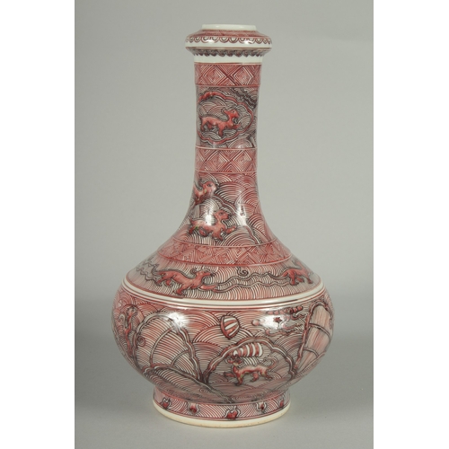 65 - A CHINESE IRON RED AND WHITE GLAZE PORCELAIN BOTTLE VASE, painted with foo dogs and various decorati... 