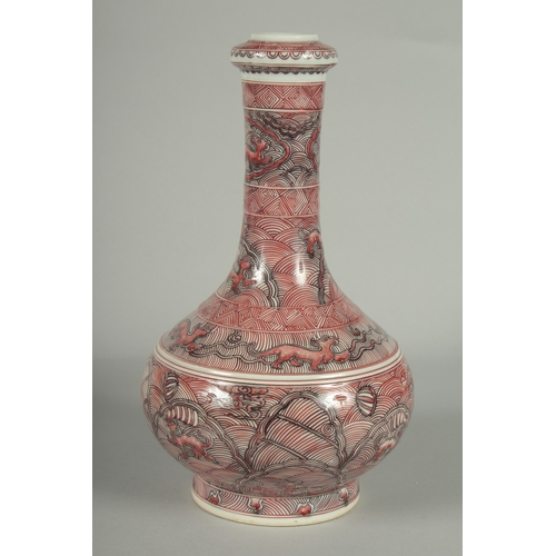 65 - A CHINESE IRON RED AND WHITE GLAZE PORCELAIN BOTTLE VASE, painted with foo dogs and various decorati... 