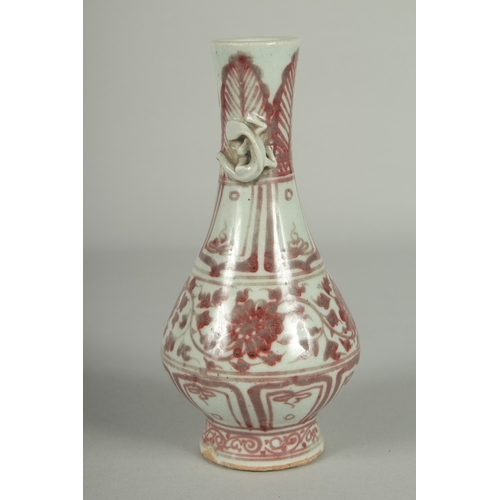 67 - A CHINESE UNDERGLAZE RED AND WHITE PORCELAIN VASE, with moulded chilong to the neck, 17cm high.