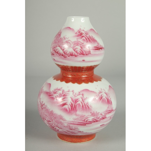 70 - A CHINESE PINK AND WHITE PORCELAIN DOUBLE GOURD VASE, painted with sweeping landscape scenes, the ba... 