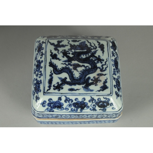 72 - A CHINESE BLUE AND WHITE PORCELAIN SQUARE-FORM BOX AND COVER, decorated with a dragon and floral mot... 