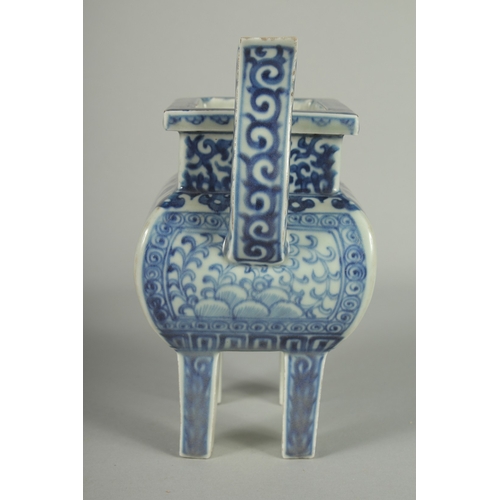 73 - A CHINESE BLUE AND WHITE PORCELAIN TWIN HANDLE CENSER, raised on four square-form feet, 19.5cm high.