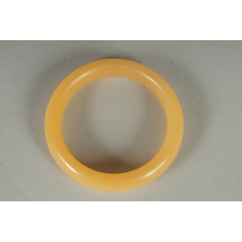 74 - AN EARLY 20TH CENTURY CHINESE YELLOW JADE BRACELET, 8cm diameter.