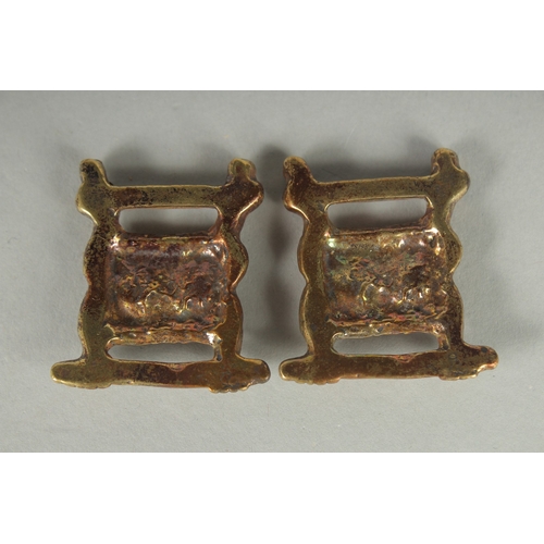 75 - TWO TIBETAN BRONZE LION HEAD ORNAMENTS.