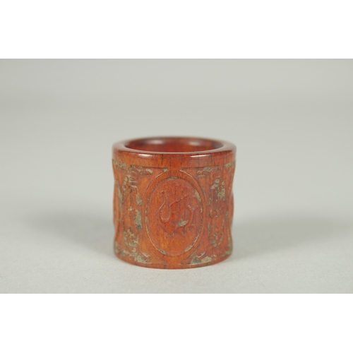 78 - A CHINESE CARVED AND STAINED BONE THUMB RING.