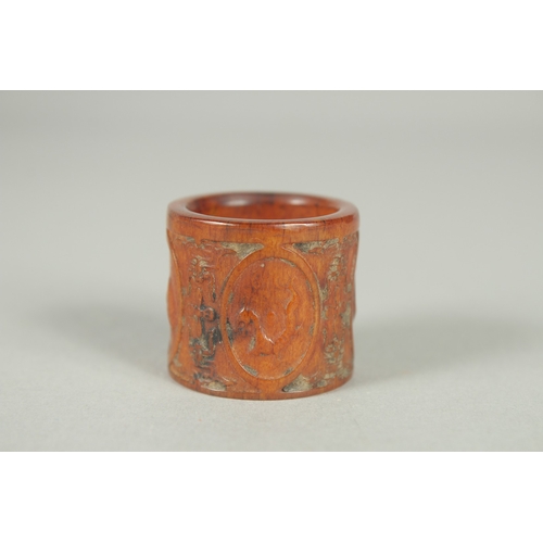 78 - A CHINESE CARVED AND STAINED BONE THUMB RING.