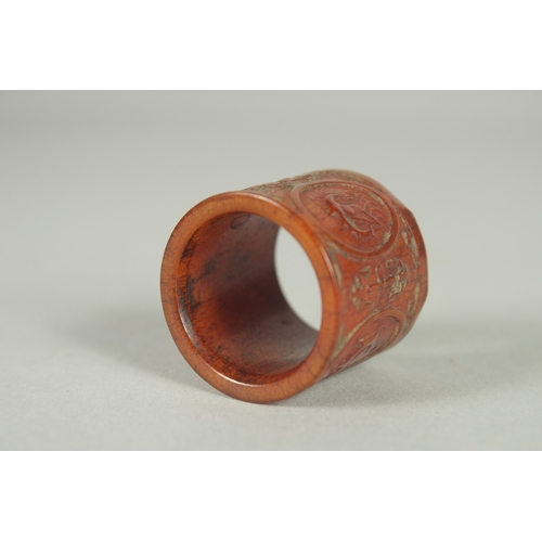 78 - A CHINESE CARVED AND STAINED BONE THUMB RING.