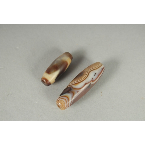 79 - TWO TIBETAN AGATE DZI BEADS.