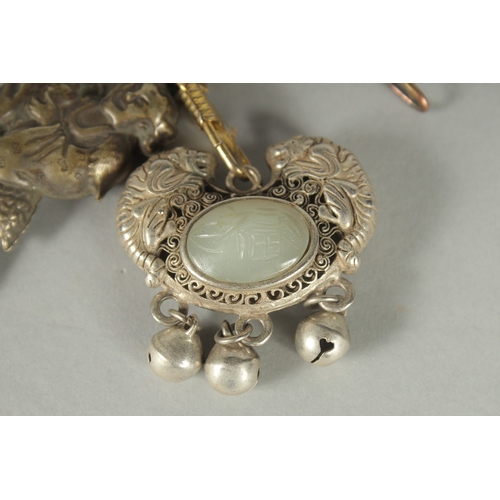 80 - A CHINESE JADE INSET WHITE PENDANT, together with another white metal pendant (2).