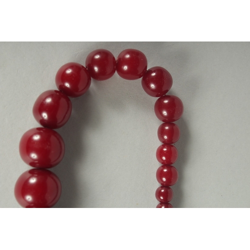 85 - A CHERRY-COLOUR BEADED NECKLACE.