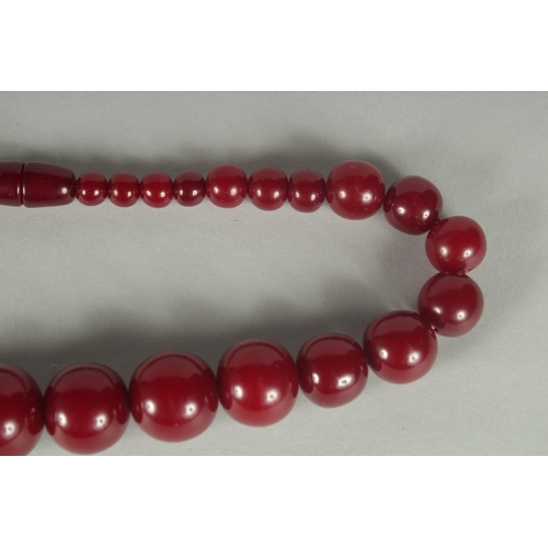 85 - A CHERRY-COLOUR BEADED NECKLACE.