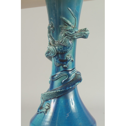 92 - A CHINESE BLUE GLAZED PORCELAIN VASE LAMP, the neck with coiling dragon, vase mounted to a hardwood ... 