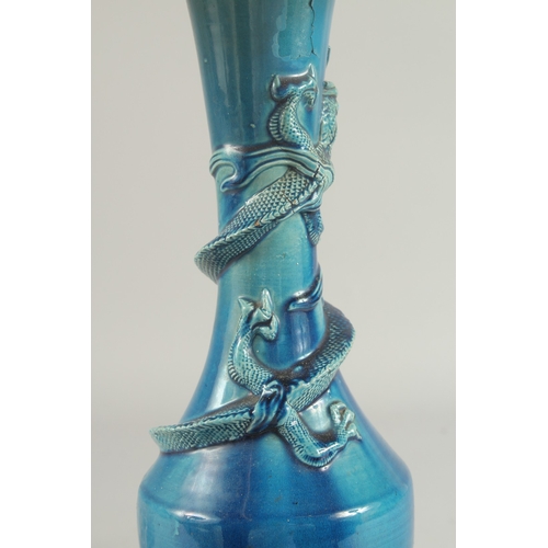 92 - A CHINESE BLUE GLAZED PORCELAIN VASE LAMP, the neck with coiling dragon, vase mounted to a hardwood ... 