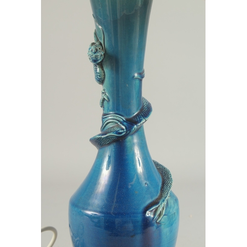 92 - A CHINESE BLUE GLAZED PORCELAIN VASE LAMP, the neck with coiling dragon, vase mounted to a hardwood ... 