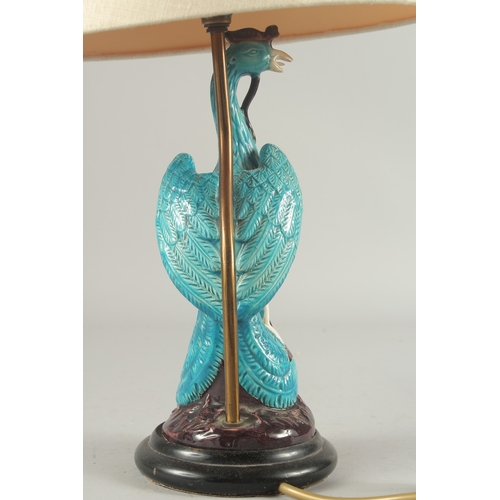 93 - A CHINESE TURQUOISE GLAZE PORCELAIN PEACOCK PHOENIX, converted to a lamp base and mounted to a circu... 