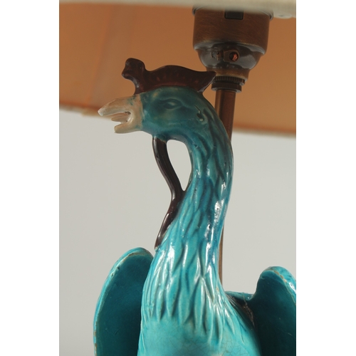 93 - A CHINESE TURQUOISE GLAZE PORCELAIN PEACOCK PHOENIX, converted to a lamp base and mounted to a circu... 