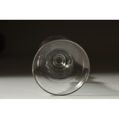 1039 - A GEORGIAN GLASS with long tapering plain bowl, knop to the stem. 7ins high.