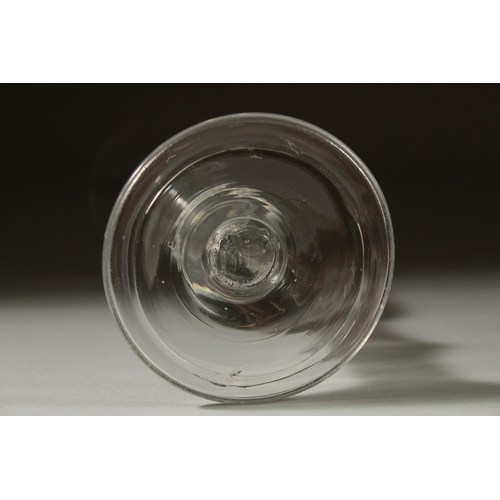 1039 - A GEORGIAN GLASS with long tapering plain bowl, knop to the stem. 7ins high.