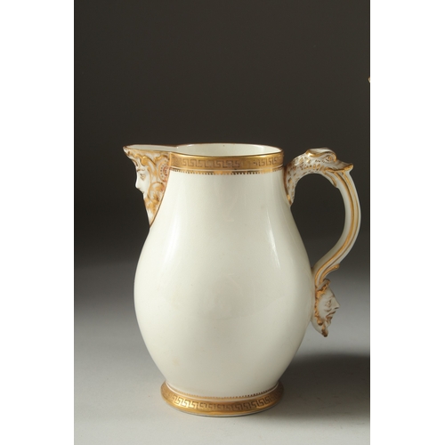 1074 - A GARNITURE OF THREE WHITE PORCELAIN GILDED JUGS with mask spouts.