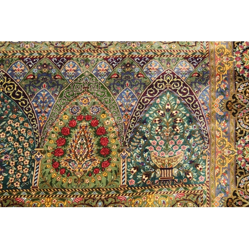 1001 - A GOOD PERSIAN SILK CARPET rich green ground with central circular floral medallion decoration all o... 