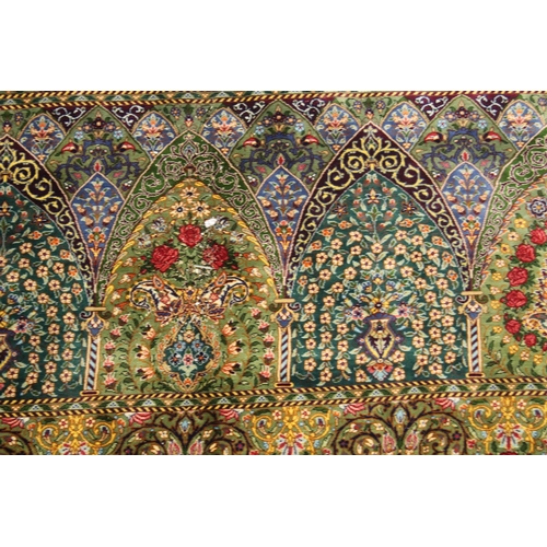 1001 - A GOOD PERSIAN SILK CARPET rich green ground with central circular floral medallion decoration all o... 