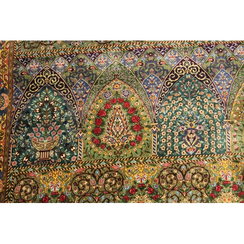 1001 - A GOOD PERSIAN SILK CARPET rich green ground with central circular floral medallion decoration all o... 