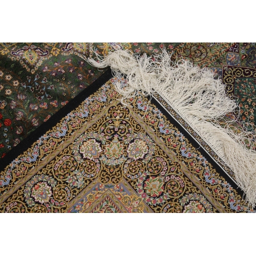 1001 - A GOOD PERSIAN SILK CARPET rich green ground with central circular floral medallion decoration all o... 