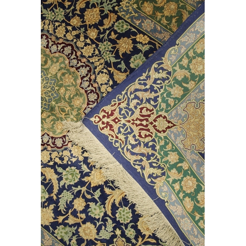 1003 - A GOOD SMALL PERSIAN SILK RUG blue ground with stylised floral decoration, with a similar green grou... 