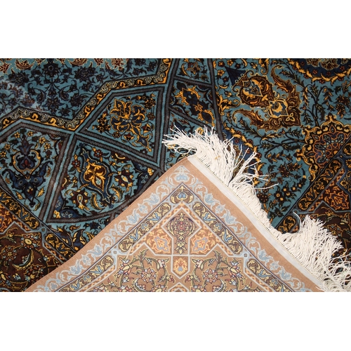 1007 - A FINE PERSIAN SILK RUG turquoise ground with stylised motifs and medallions. Signed. 6ft 6ins x 4ft... 