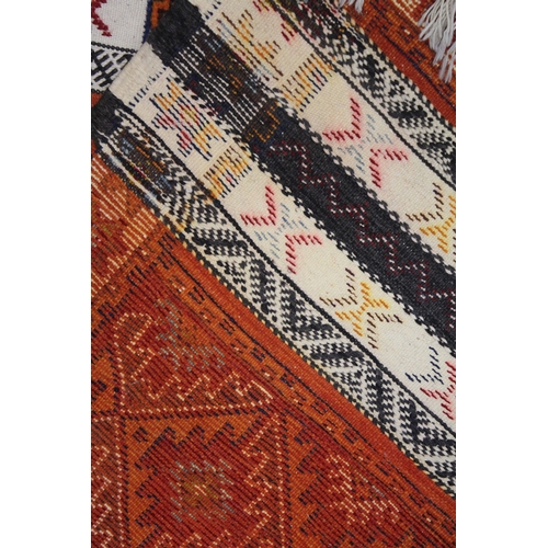 1013 - A PERSIAN/ NORTH AFRICAN WOOL RUNNER with bands of sylised decoration. 9ft 10ins x 2ft 8ins.