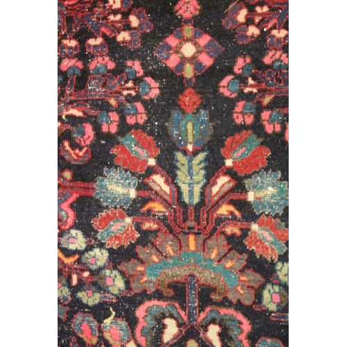 1014 - A PERSIAN WOOL RUNNER OR HALL CARPET dark blue ground with large floral design. 9ft 11ins x 3ft 8ins... 