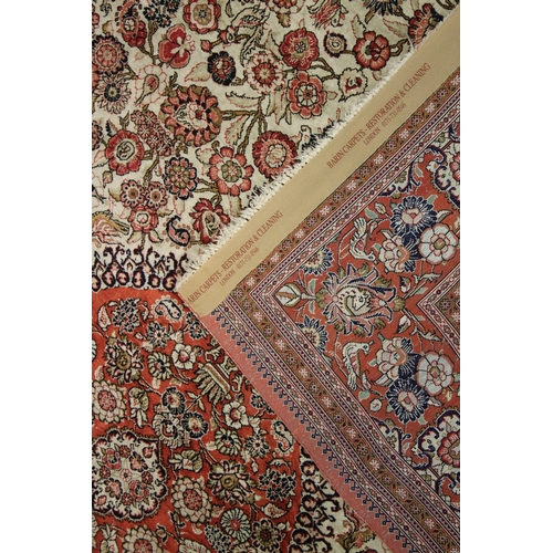 1019 - A GOOD PERSIAN SILK CARPET cream ground with floral decoration with a red ground border. Signed. 6ft... 