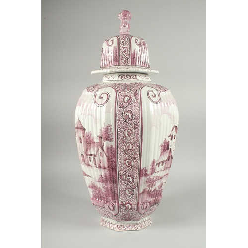 1071 - A LARGE DUTCH POTTERY RIBBED VASE AND COVER with reverse scenes of buildings, the lid with kylin han... 