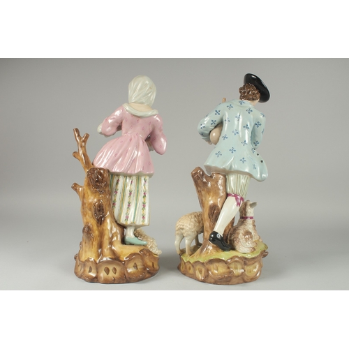 1086 - A LARGE PAIR OF PORCELAIN GROUPS OF A  GALLANT AND A YOUNG LADY, sheep at her feet. 16.5ins high.... 