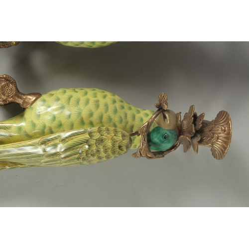 1087 - A GOOD PAIR OF PORCELAIN GREEN  PARROT WALL SCONCES with gilt metal surrounds. 18.5ins long.